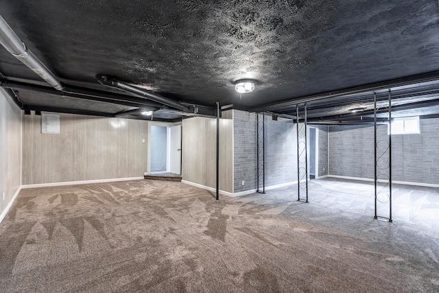 basement with carpet flooring and brick wall