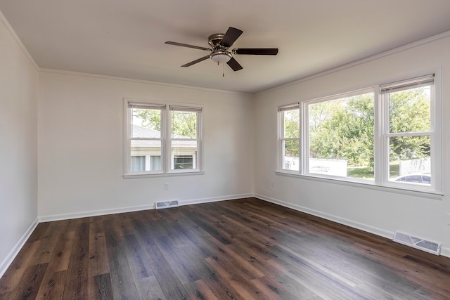 unfurnished room with plenty of natural light, dark hardwood / wood-style floors, and crown molding