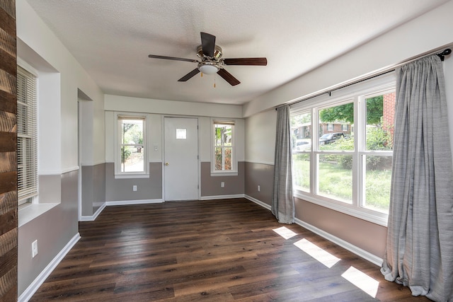 foyer entrance featuring ceiling fan, dark hardwood / wood-style flooring, and a textured ceiling