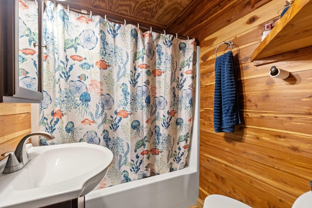 full bathroom with sink, shower / bath combination with curtain, toilet, wooden walls, and wood ceiling