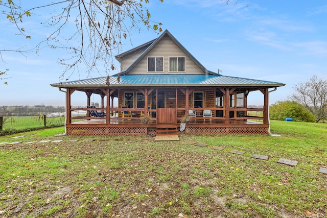 rear view of property featuring a yard