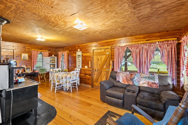 living room with wood-type flooring and wooden walls