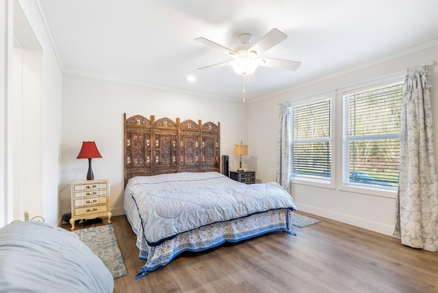 bedroom featuring ceiling fan, ornamental molding, and hardwood / wood-style flooring