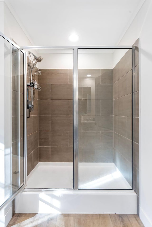 bathroom featuring hardwood / wood-style flooring and an enclosed shower