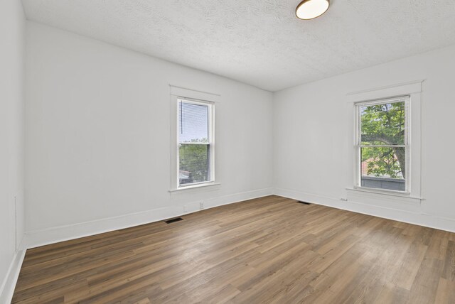 kitchen featuring tasteful backsplash, white cabinets, stainless steel appliances, and light wood-type flooring