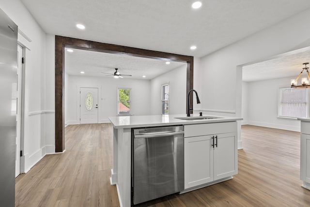 kitchen featuring dishwasher, sink, a textured ceiling, white cabinets, and light wood-type flooring