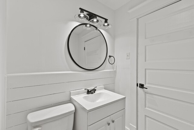 kitchen with a textured ceiling, stainless steel appliances, sink, white cabinets, and light hardwood / wood-style floors