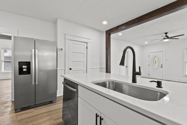 empty room with hardwood / wood-style floors, a textured ceiling, and ceiling fan