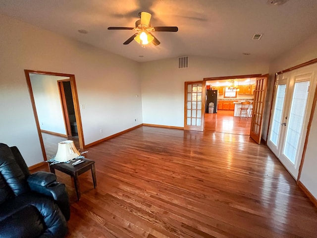 unfurnished living room featuring ceiling fan, french doors, vaulted ceiling, and hardwood / wood-style flooring