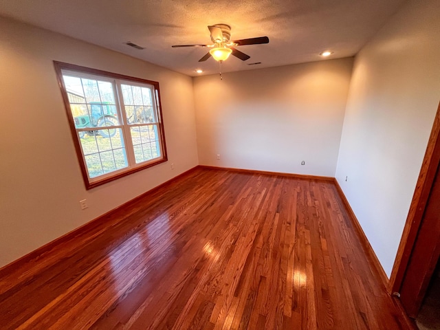 unfurnished room with hardwood / wood-style floors and ceiling fan