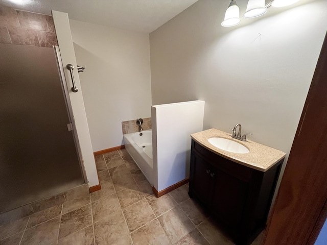 bathroom with vanity and independent shower and bath