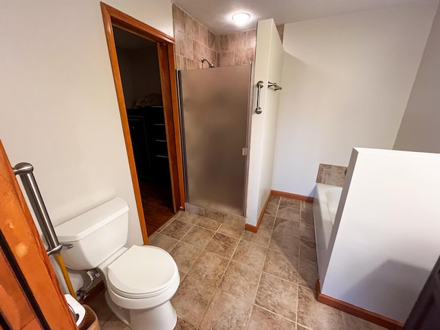 bathroom featuring separate shower and tub and toilet