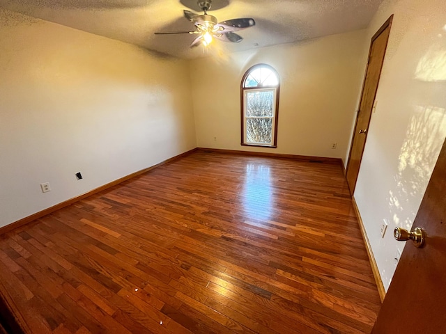 empty room featuring wood-type flooring, a textured ceiling, and ceiling fan