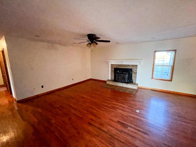 unfurnished living room featuring ceiling fan, wood-type flooring, and a textured ceiling