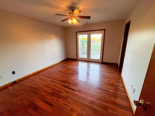 empty room featuring dark hardwood / wood-style flooring, ceiling fan, and french doors