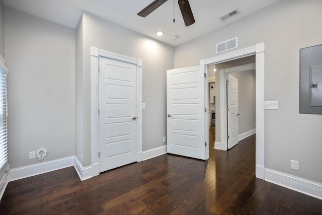 unfurnished bedroom featuring baseboards, visible vents, and dark wood-style flooring