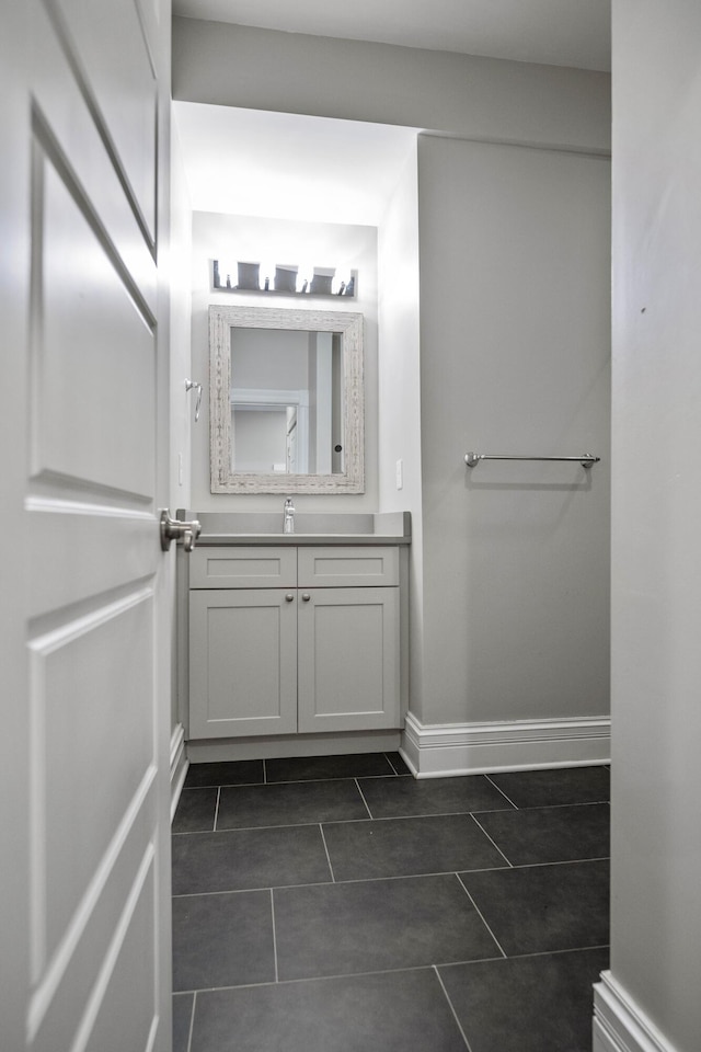 bathroom featuring tile patterned floors, vanity, and baseboards