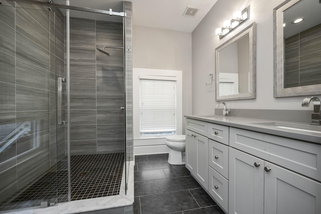 bathroom with a sink, visible vents, toilet, and double vanity