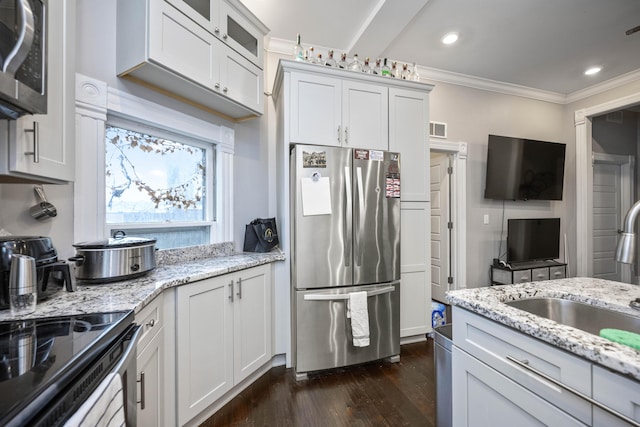 kitchen with crown molding, appliances with stainless steel finishes, dark wood-style floors, white cabinetry, and a sink