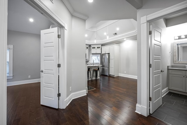 hallway featuring dark wood-type flooring, recessed lighting, and baseboards