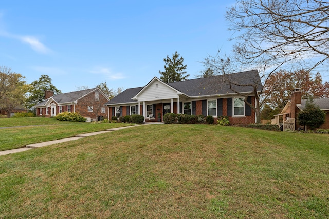 single story home featuring covered porch and a front lawn