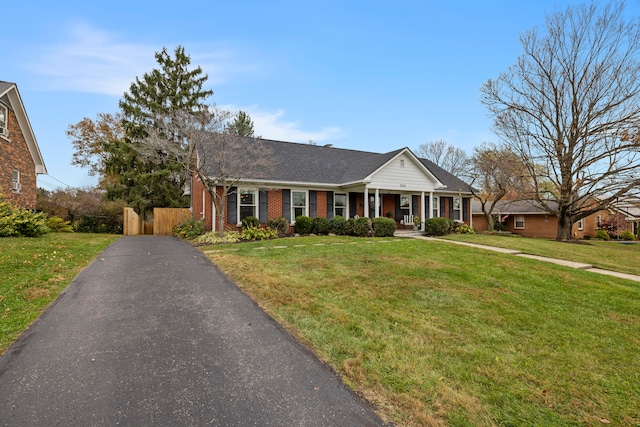 view of front of home with a front yard and a porch