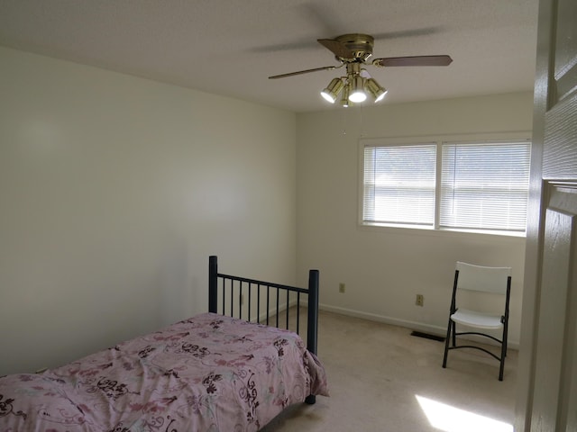 unfurnished room with carpet flooring, ceiling fan, and a textured ceiling