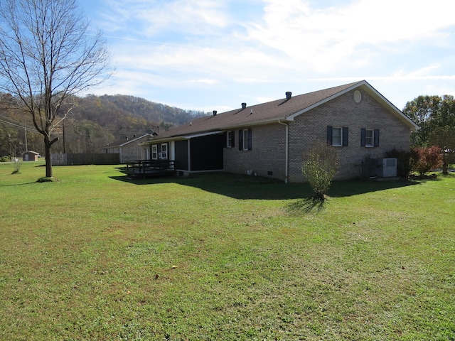 back of property featuring a yard and central AC unit