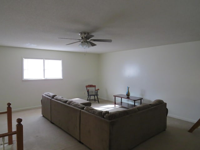 bedroom with a closet, ceiling fan, and light colored carpet