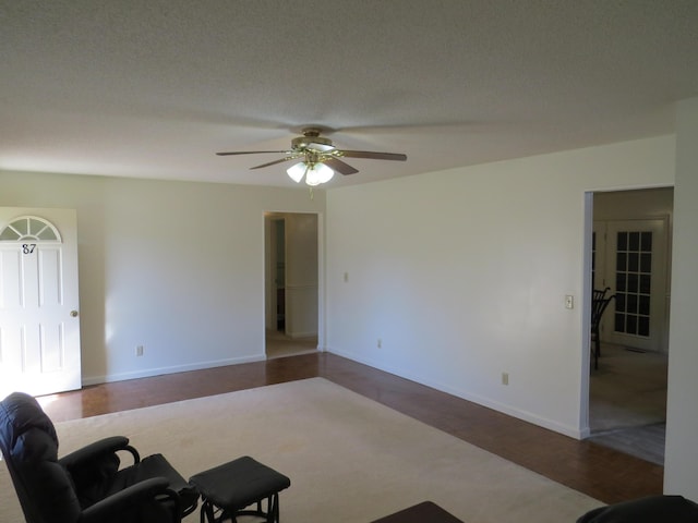 dining area with ceiling fan and light carpet