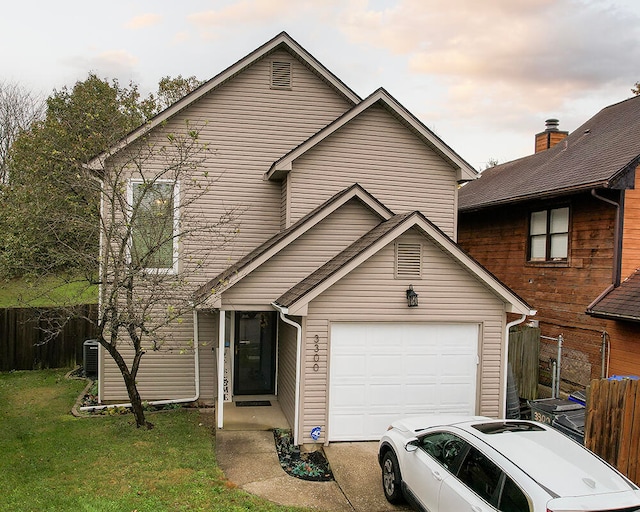 front of property featuring a yard and a garage