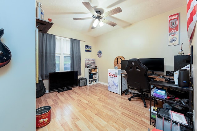 home office featuring ceiling fan and light hardwood / wood-style floors