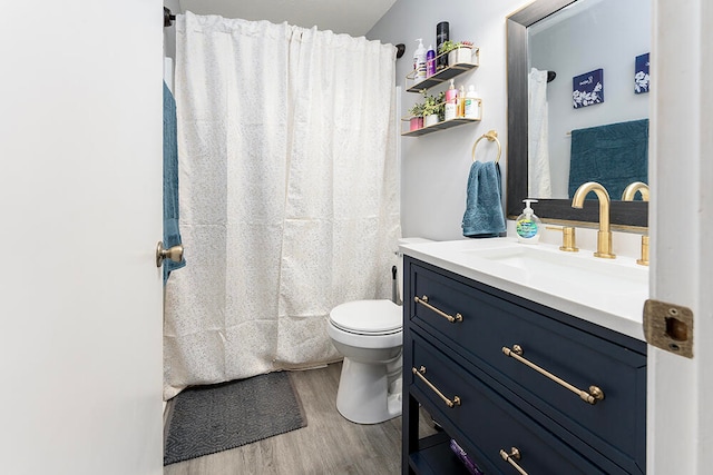 bathroom with hardwood / wood-style floors, vanity, and toilet