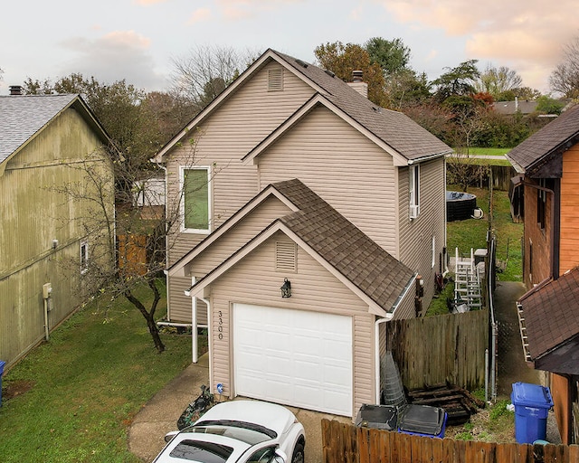 view of front of house featuring a yard and a garage