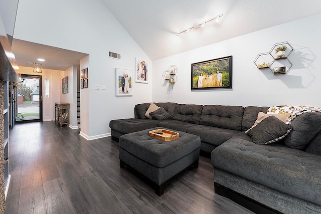 living room with dark hardwood / wood-style flooring and high vaulted ceiling