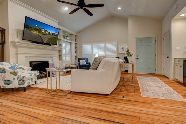 living room with light wood-type flooring, high vaulted ceiling, and ceiling fan