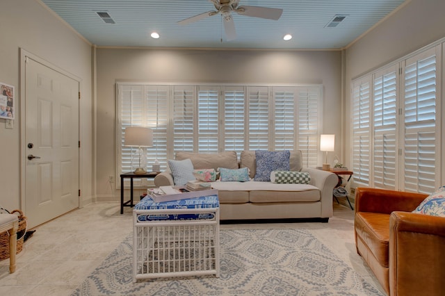 living room with ceiling fan, light tile patterned floors, and crown molding