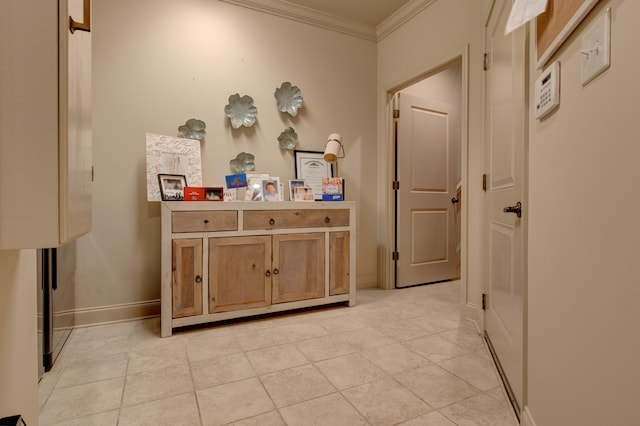 hall with ornamental molding and light tile patterned floors