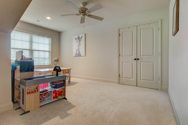 office space with light carpet and ceiling fan