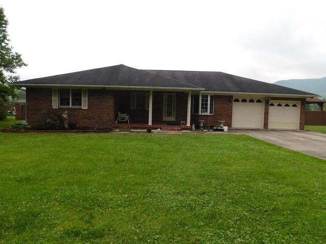 ranch-style home featuring a garage and a front lawn