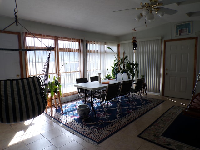 dining room featuring tile patterned flooring, a textured ceiling, plenty of natural light, and ceiling fan