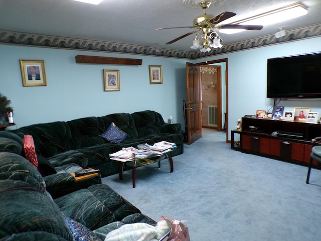 living room featuring carpet, a textured ceiling, and ceiling fan