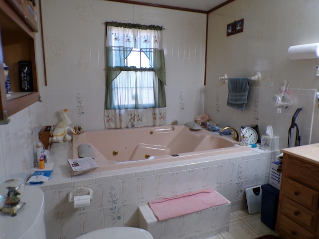 bathroom with a relaxing tiled tub, tile walls, and toilet