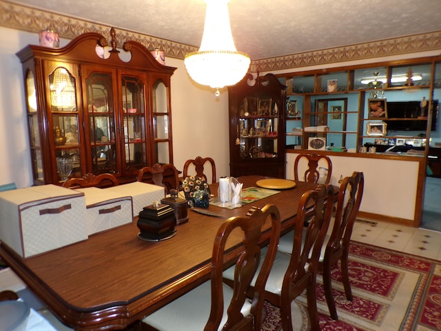 dining area with a chandelier and a textured ceiling