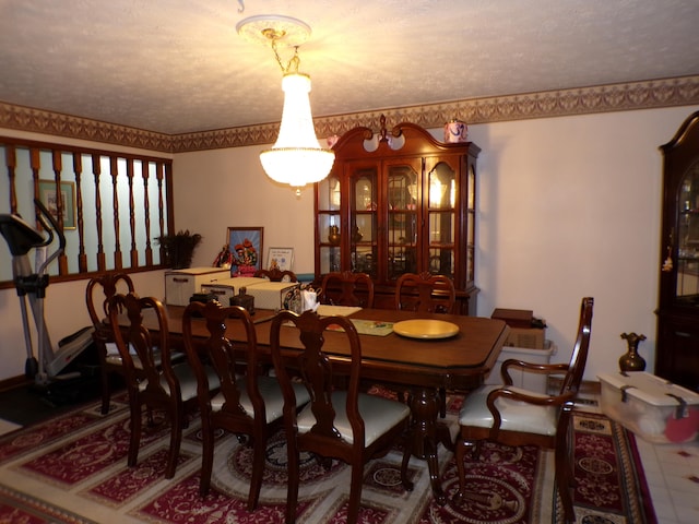 dining area featuring a textured ceiling and a notable chandelier