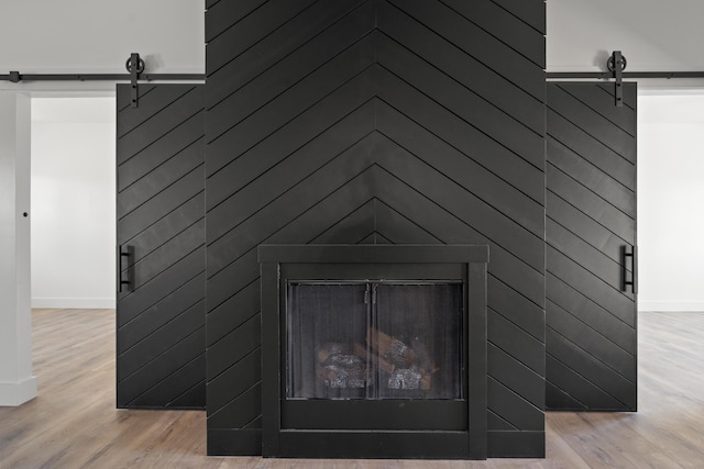 interior details with hardwood / wood-style flooring and a barn door