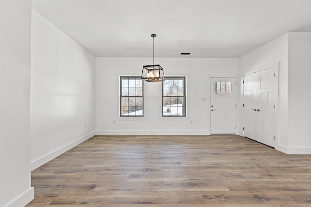 entrance foyer featuring an inviting chandelier and light wood-type flooring