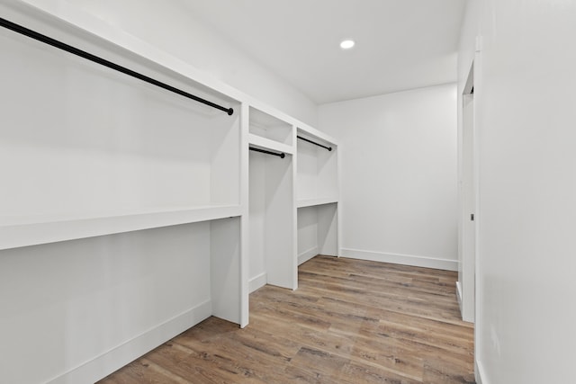 spacious closet with hardwood / wood-style flooring and a barn door