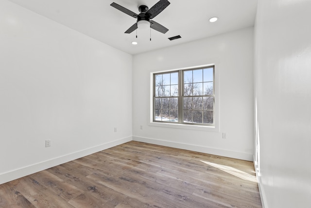 unfurnished room with ceiling fan and light wood-type flooring