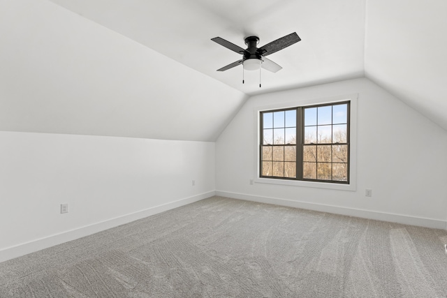 additional living space with vaulted ceiling, carpet flooring, and ceiling fan